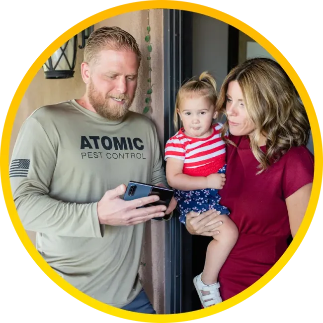 Atomic Pest Control, technician speaking with customer at home